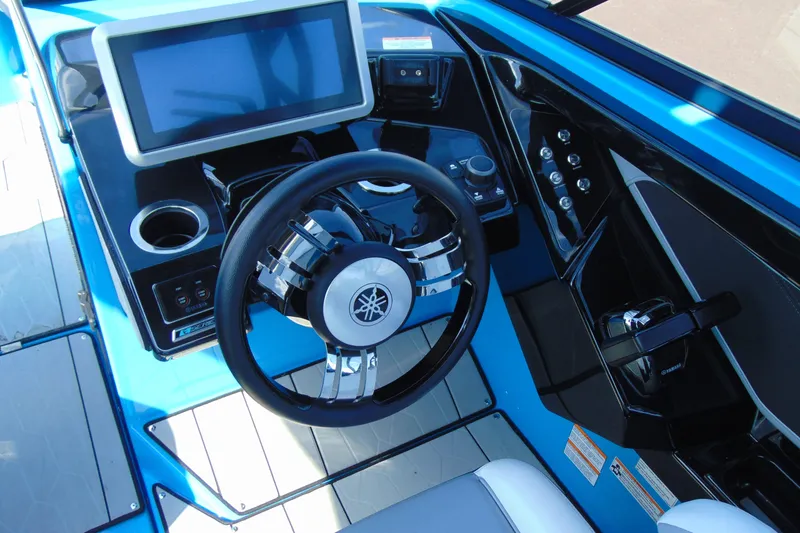 Slide: The Image of 2022 Yamaha Boats 255XD cockpit with steering wheel and touchscreen display. - 14