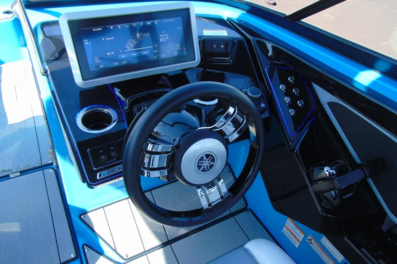 Slide: The Image of 2022 Yamaha Boats 255XD helm with touchscreen display and sleek steering wheel. - 17