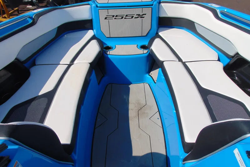 Slide: The Image of Interior view of a 2022 Yamaha Boats 255XD, featuring blue and white seating. - 18