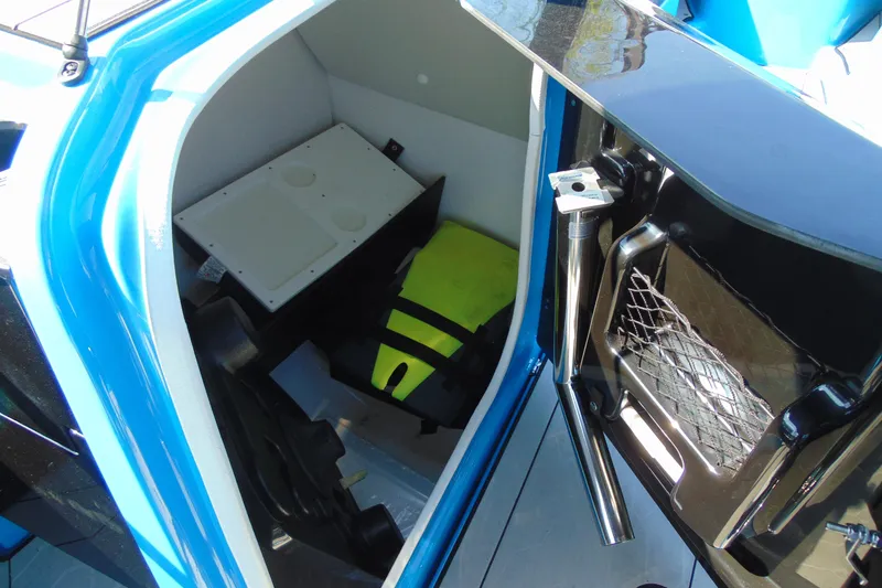 Slide: The Image of Storage compartment of 2022 Yamaha Boats 255XD, featuring safety equipment and accessories. - 21