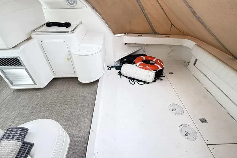 Slide: The Image of 1998 Sea Ray 370 Express Cruiser interior with life preserver and storage area. - 10