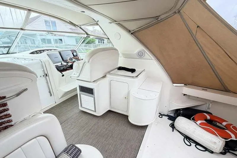 Slide: The Image of 1998 Sea Ray 370 Express Cruiser interior with helm, seating, and life preserver. - 11