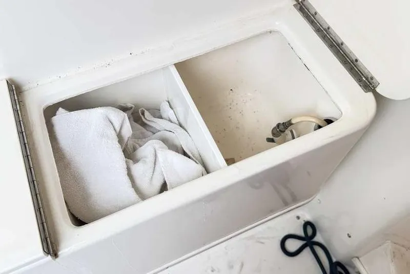 Slide: The Image of Storage compartment on a 1998 Sea Ray 370 Express Cruiser with towel and hose. - 12