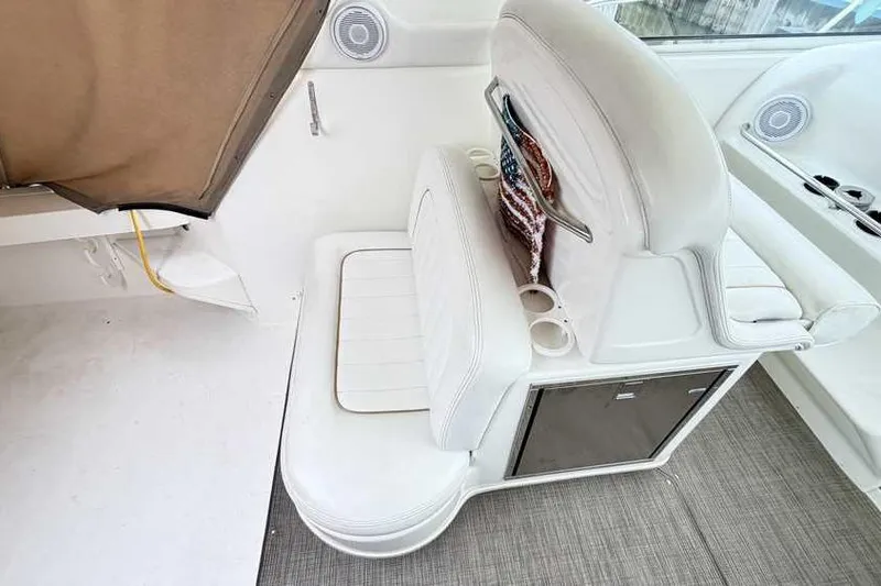 Slide: The Image of 1998 Sea Ray 370 Express Cruiser interior with white seating and storage. - 13