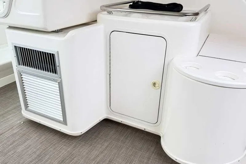 Slide: The Image of 1998 Sea Ray 370 Express Cruiser interior with storage compartment and vent. - 16