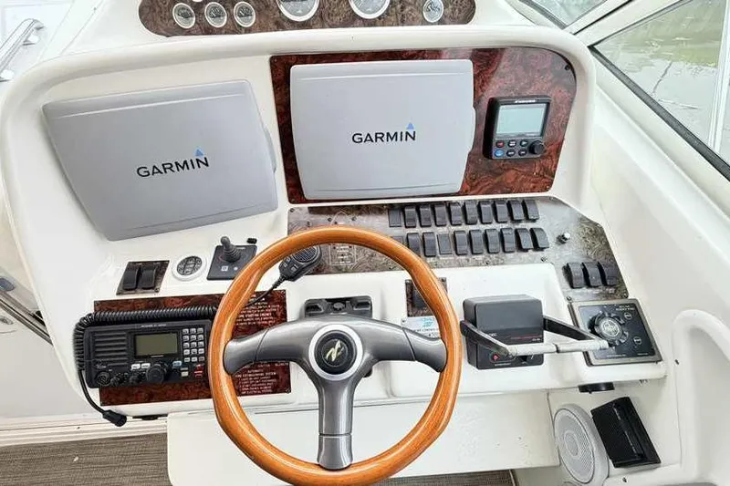 Slide: The Image of 1998 Sea Ray 370 Express Cruiser helm with Garmin navigation and wooden steering wheel. - 23