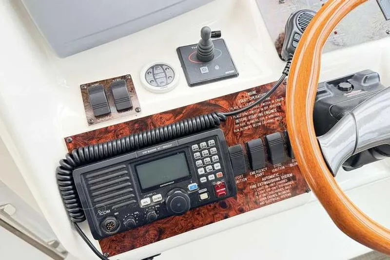 Slide: The Image of Control panel of a 1998 Sea Ray 370 Express Cruiser with radio and steering wheel. - 26
