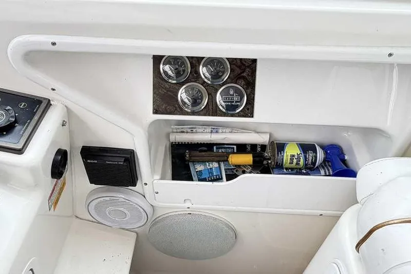 Slide: The Image of 1998 Sea Ray 370 Express Cruiser dashboard with gauges and storage compartment. - 27