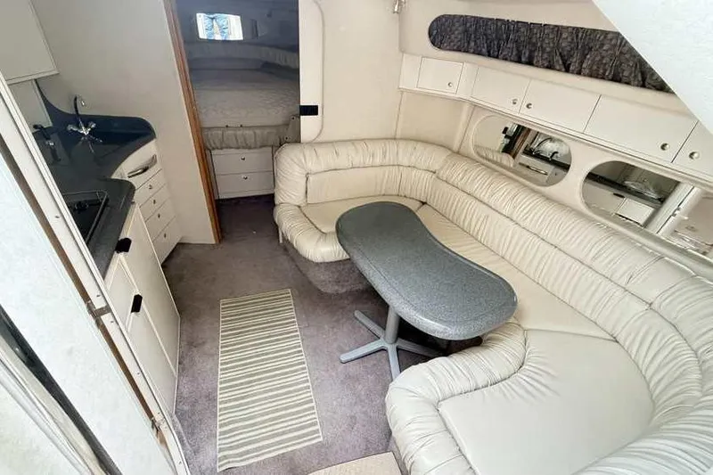 Slide: The Image of Interior of 1998 Sea Ray 370 Express Cruiser with leather seating and compact kitchen. - 29