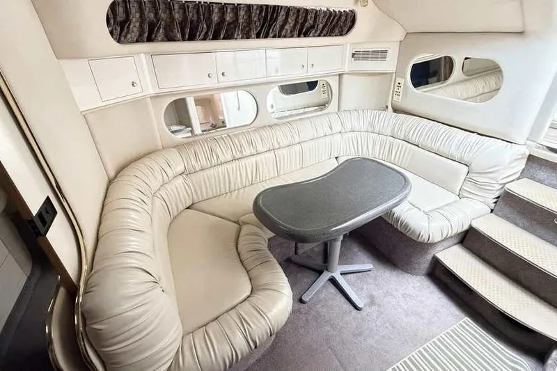 Slide: The Image of Luxurious interior of 1998 Sea Ray 370 Express Cruiser with plush seating and table. - 30