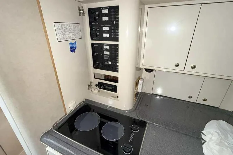 Slide: The Image of 1998 Sea Ray 370 Express Cruiser kitchen with stove and control panel. - 34