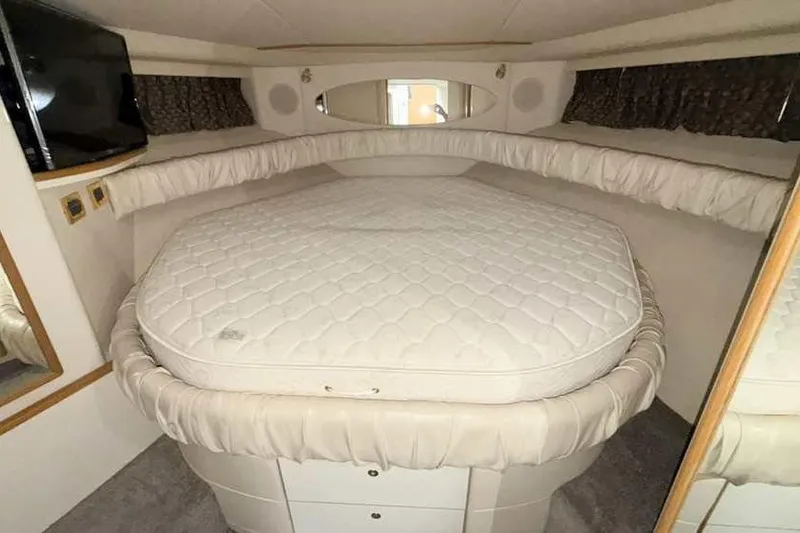 Slide: The Image of 1998 Sea Ray 370 Express Cruiser cabin with bed and TV. - 38
