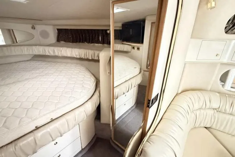 Slide: The Image of Interior of 1998 Sea Ray 370 Express Cruiser with cozy bed and seating area. - 40