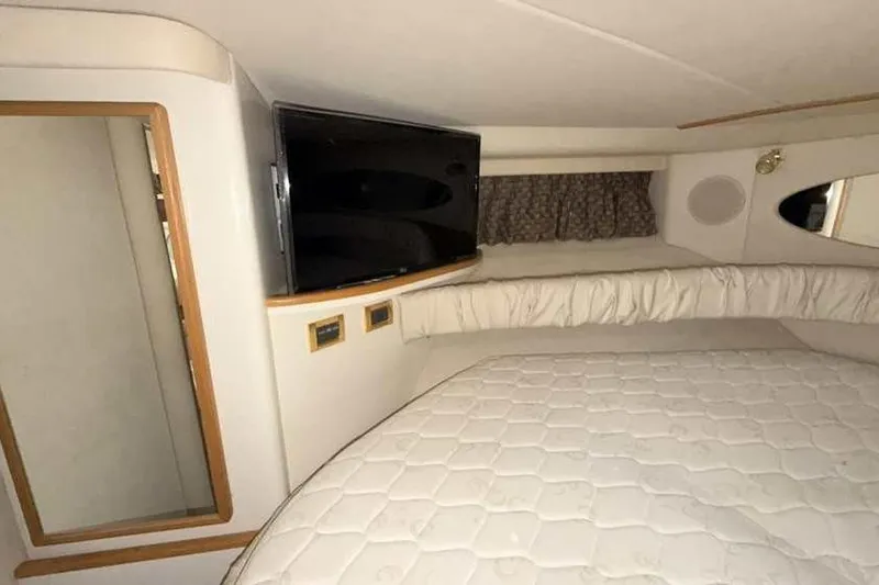 Slide: The Image of Interior cabin of 1998 Sea Ray 370 Express Cruiser with bed and TV. - 44