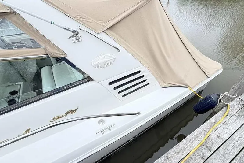 Slide: The Image of 1998 Sea Ray 370 Express Cruiser docked with beige canopy cover. - 5