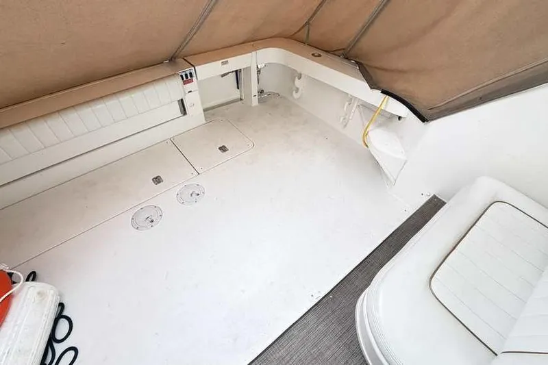 Slide: The Image of 1998 Sea Ray 370 Express Cruiser interior with white seating and storage compartments. - 9