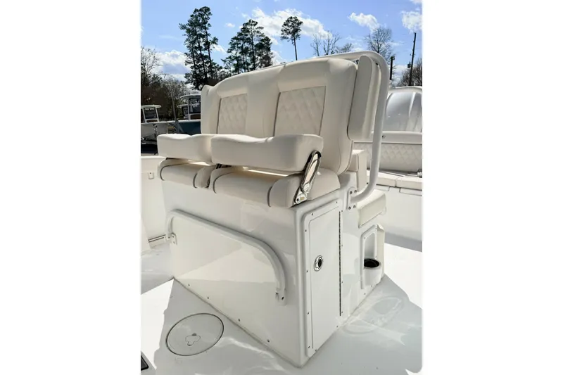 Slide: The Image of 2026 Sea Hunt Ultra 255 SE boat seating with white cushioned seats and storage compartments. - 10