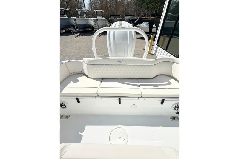 Slide: The Image of 2026 Sea Hunt Ultra 255 SE boat interior with white cushioned seating. - 13