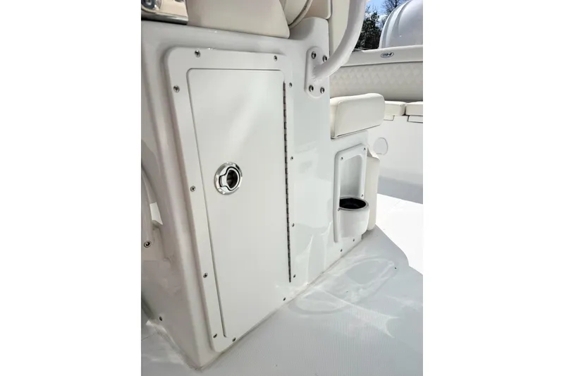 Slide: The Image of 2026 Sea Hunt Ultra 255 SE boat interior storage compartment and cup holder. - 15