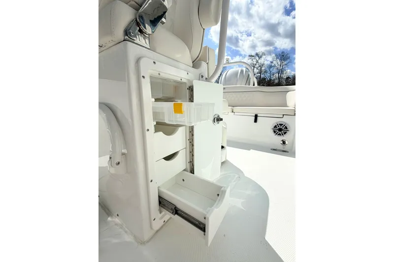 Slide: The Image of Storage compartment on 2026 Sea Hunt Ultra 255 SE boat, featuring drawers and tackle box. - 16