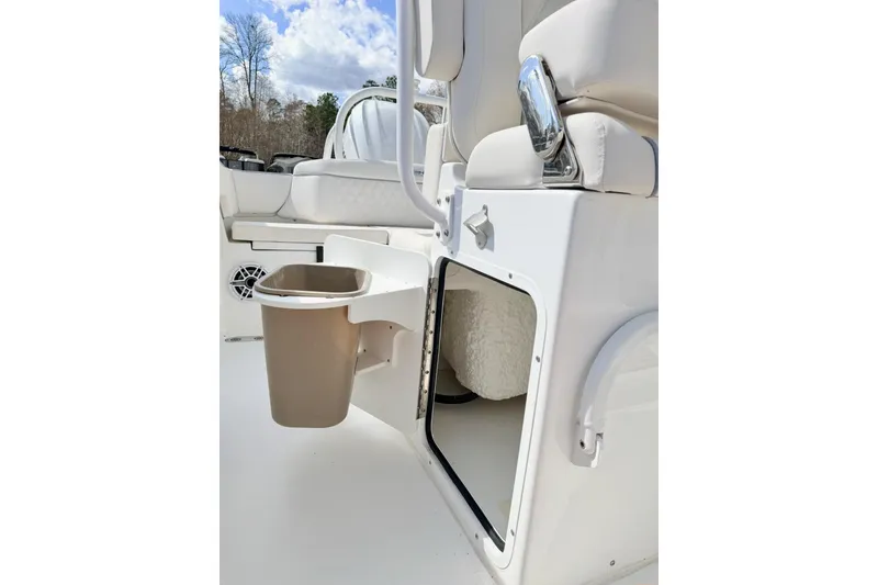 Slide: The Image of 2026 Sea Hunt Ultra 255 SE boat interior with storage compartment and trash bin. - 17