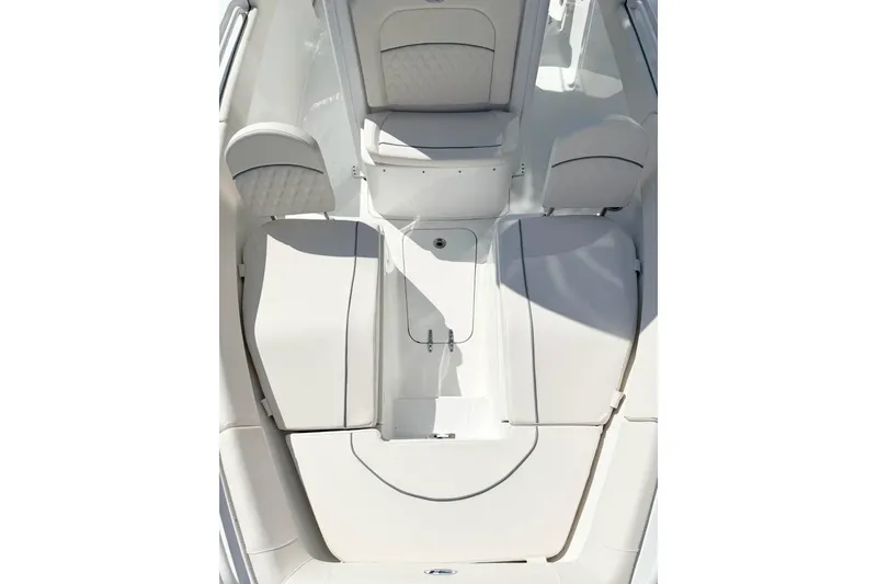 Slide: The Image of 2026 Sea Hunt Ultra 255 SE boat interior with cushioned seating and storage compartments. - 19