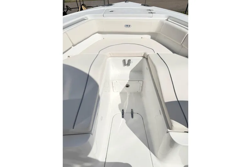 Slide: The Image of 2026 Sea Hunt Ultra 255 SE boat interior with cushioned seating and storage. - 21