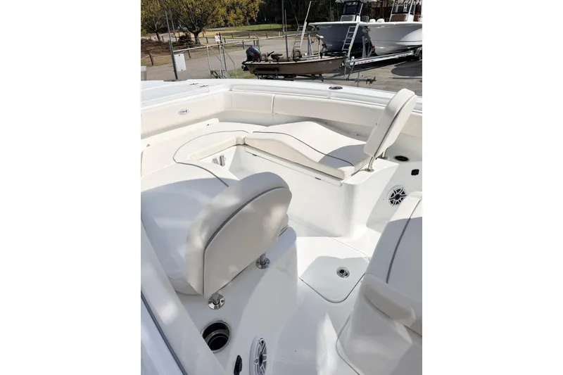 Slide: The Image of 2026 Sea Hunt Ultra 255 SE boat interior with white seating and deck. - 22