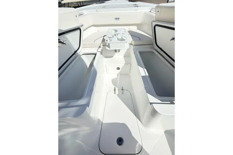 Slide: The Image of 2026 Sea Hunt Ultra 255 SE boat interior with open storage compartments and seating area. - 27