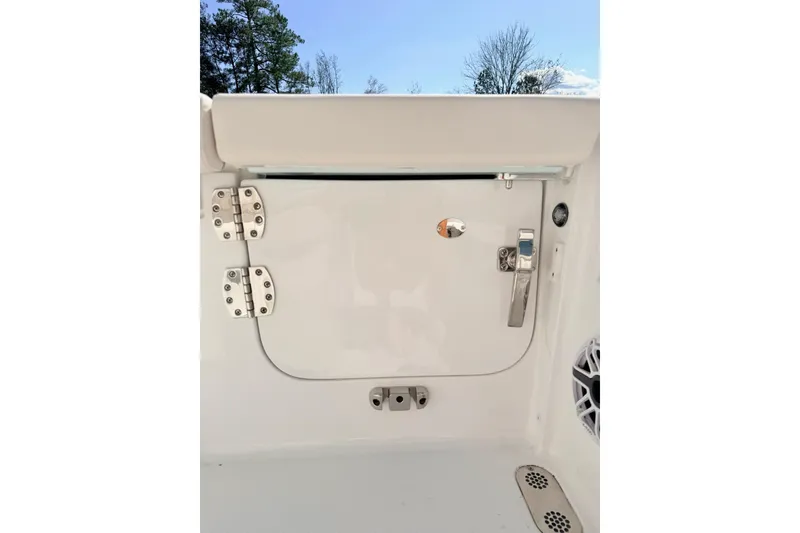 Slide: The Image of 2026 Sea Hunt Ultra 255 SE boat hatch with stainless steel hinges and latch. - 5