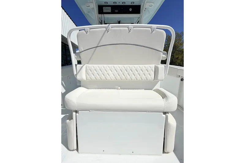 Slide: The Image of 2026 Sea Hunt Ultra 255 SE boat with white cushioned seating and backrest. - 6