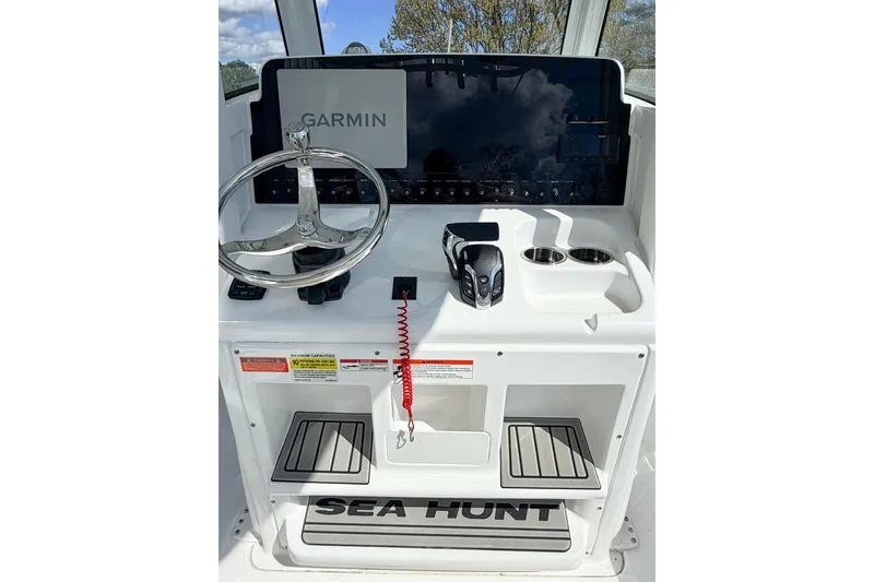 Slide: The Image of 2026 Sea Hunt Ultra 255 SE boat console with Garmin display and steering wheel. - 8