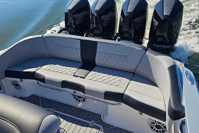 Slide: The Image of 2025 Nor-Tech 390 Sport Center Console with luxurious seating and powerful engines. - 12