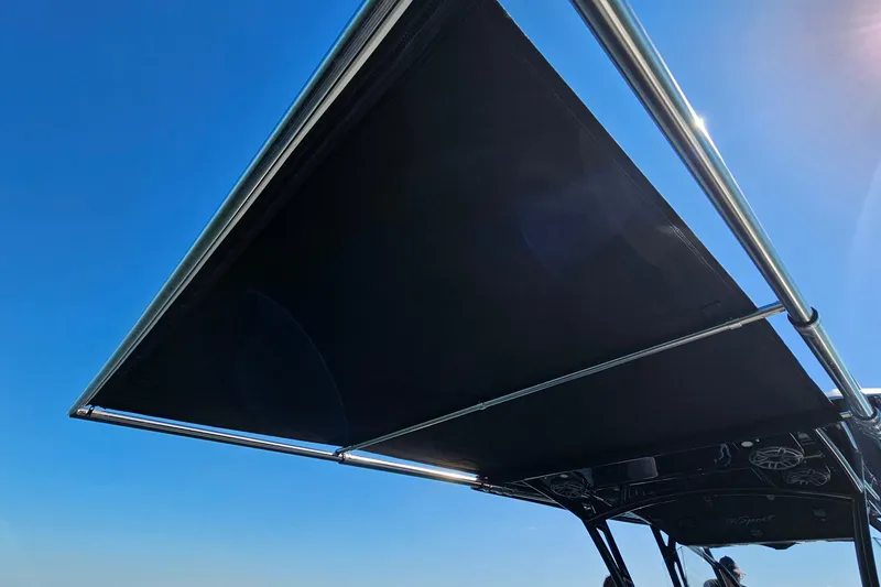 Slide: The Image of 2025 Nor-Tech 390 Sport Center Console with sunshade against clear blue sky. - 16