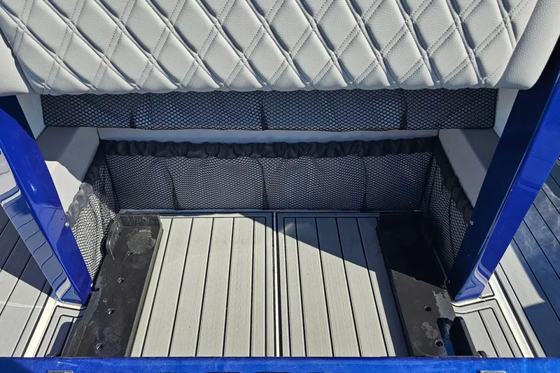 Slide: The Image of 2025 Nor-Tech 390 Sport Center Console interior with quilted seating and storage compartments. - 18