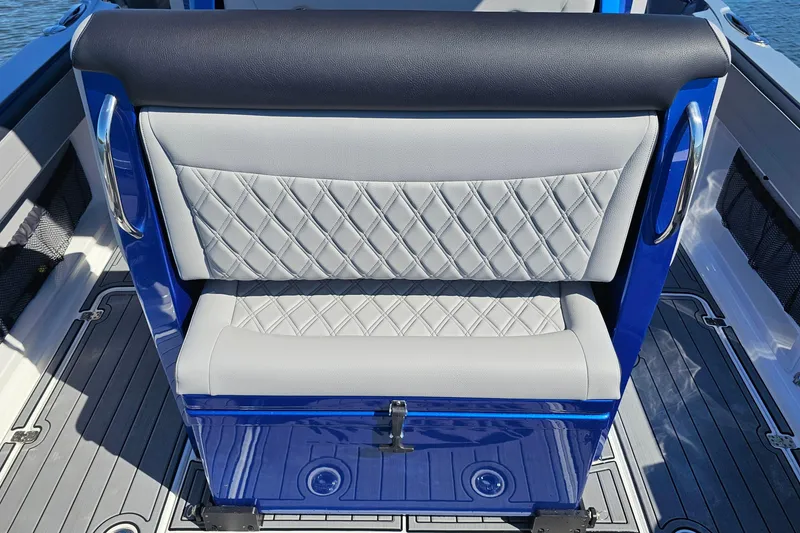 Slide: The Image of 2025 Nor-Tech 390 Sport Center Console seat with diamond-stitched upholstery and sleek blue accents. - 20