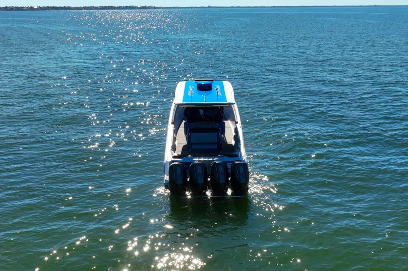 Slide: The Image of 2025 Nor-Tech 390 Sport Center Console boat on sparkling blue water. - 3