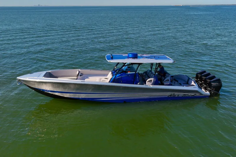 Slide: The Image of 2025 Nor-Tech 390 Sport Center Console boat on calm water. - 5