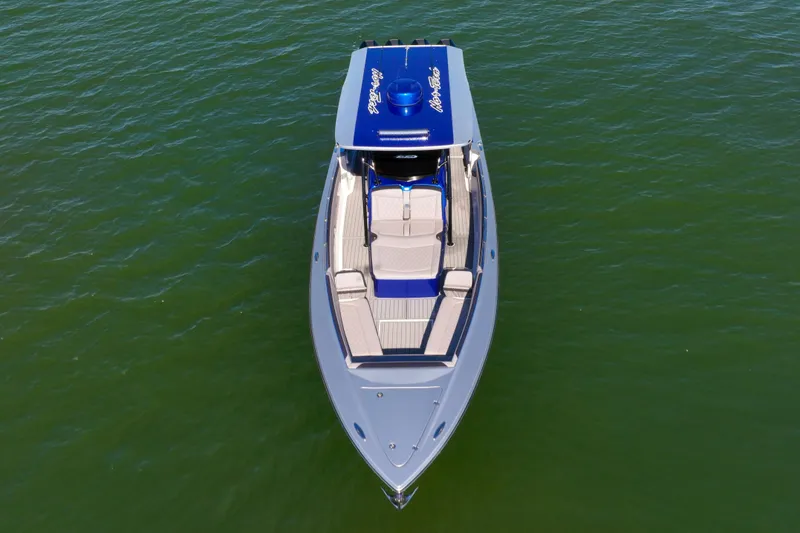 Slide: The Image of 2025 Nor-Tech 390 Sport Center Console boat on calm green water, aerial view. - 8