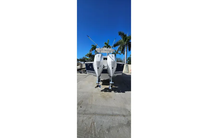 Slide: The Image of 2007 SeaCraft SC32 Master Angler boat on trailer, clear sky, palm trees in background. - 14