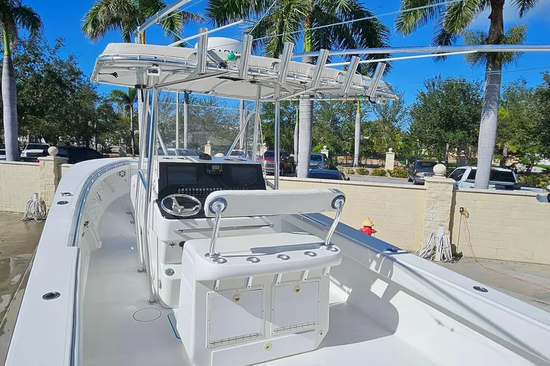 Slide: The Image of 2007 SeaCraft SC32 Master Angler boat with center console, docked under palm trees. - 16