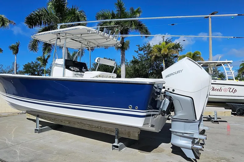 Slide: The Image of 2007 SeaCraft SC32 Master Angler boat with Mercury engine, displayed outdoors under palm trees. - 3