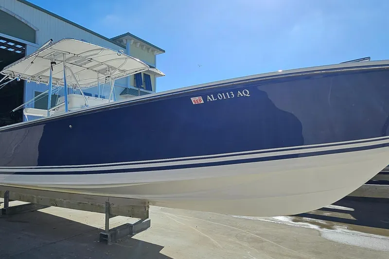 Slide: The Image of 2007 SeaCraft SC32 Master Angler boat with blue hull, docked outdoors. - 5