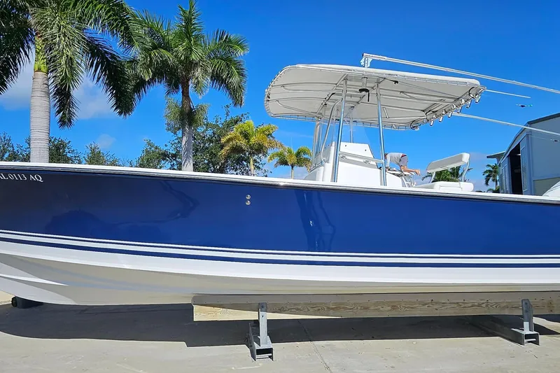 Slide: The Image of 2007 SeaCraft SC32 Master Angler boat with blue hull, docked under palm trees. - 8