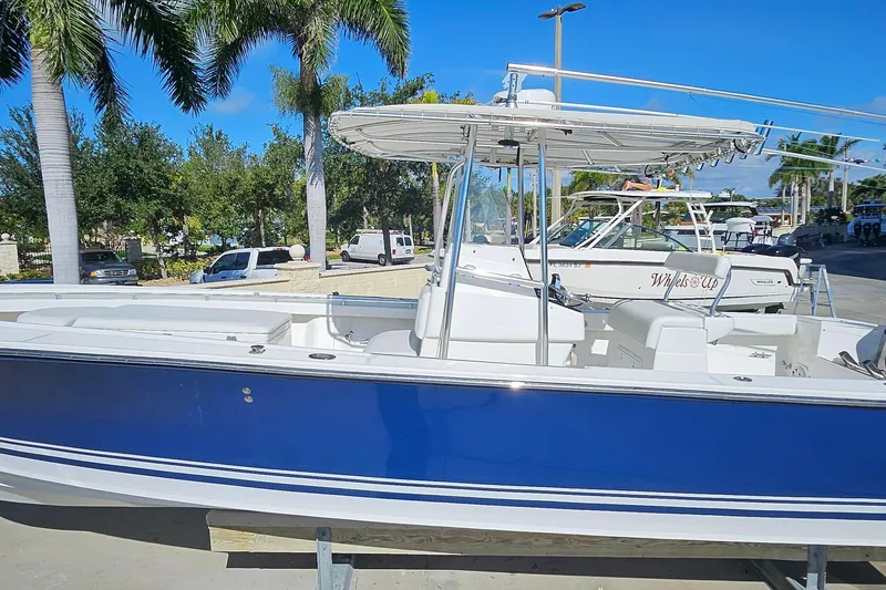 Slide: The Image of 2007 SeaCraft SC32 Master Angler boat with blue hull, docked under palm trees. - 9