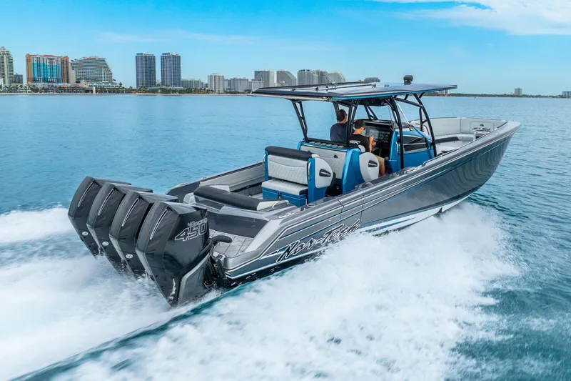 Slide: The Image of 2024 Nor-Tech 390 Sport Center Console cruising on water with city skyline in background. - 15