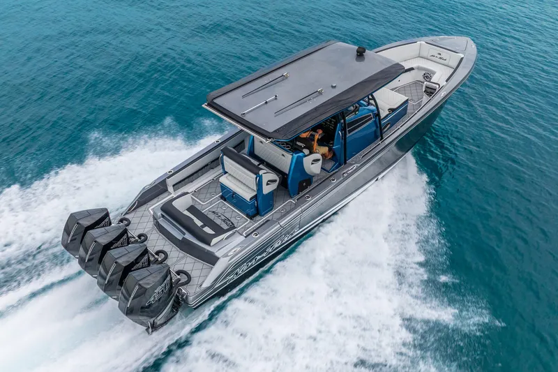 Slide: The Image of 2024 Nor-Tech 390 Sport Center Console cruising on clear blue water. - 16