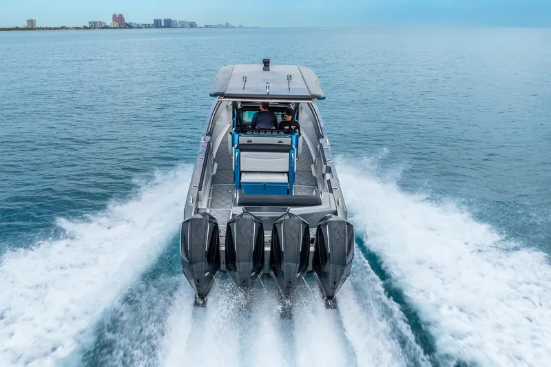Slide: The Image of 2024 Nor-Tech 390 Sport Center Console cruising on open water, rear view. - 17