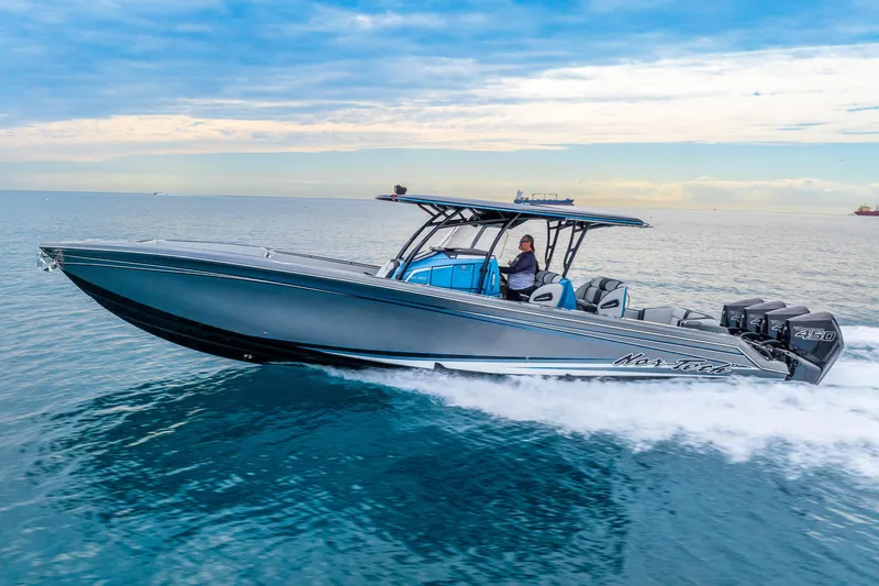 Slide: The Image of 2024 Nor-Tech 390 Sport Center Console cruising on open water. - 19