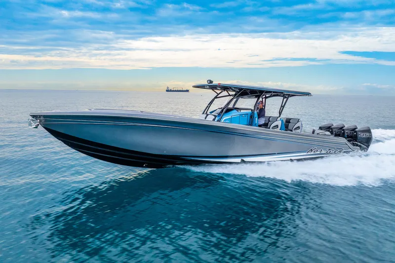 Slide: The Image of 2024 Nor-Tech 390 Sport Center Console cruising on open water under a clear sky. - 20